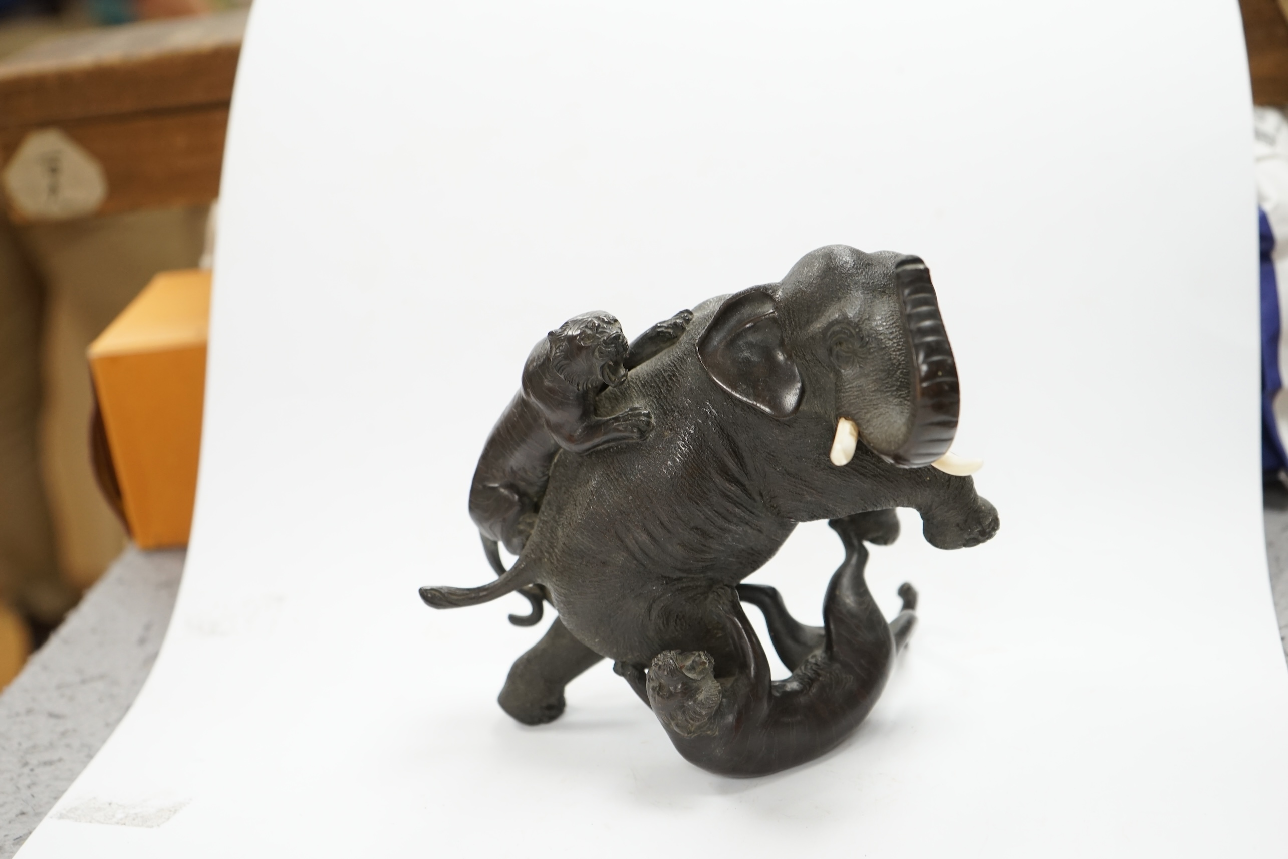 After Genryusai Seiya (1868-1912), a 19th century Japanese Meiji period cast bronze group of an elephant being attacked by tigers, seal mark, 14cm high. CITES Submission reference P5SHZWF1. Condition - good